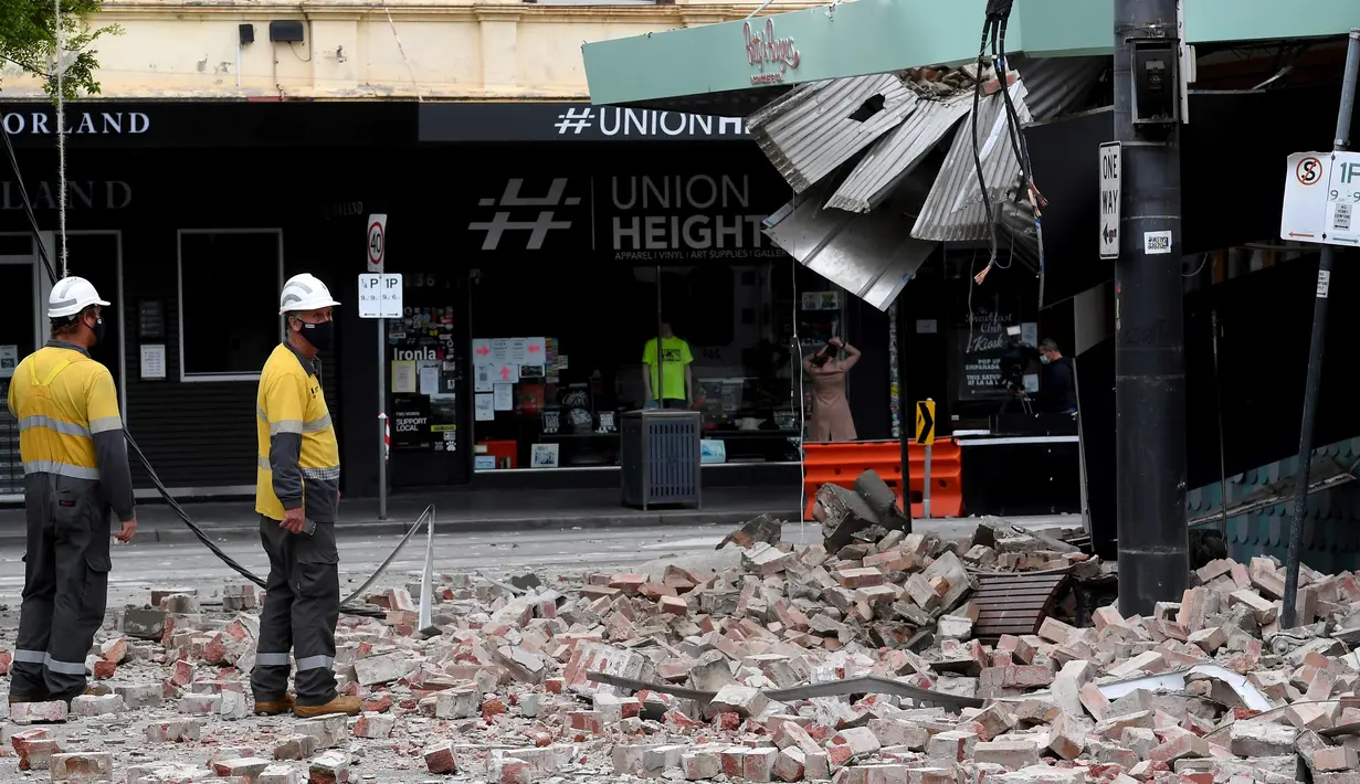 Petugas darurat dan penyelamatan memeriksa bangunan yang rusak setelah gempa di pusat perbelanjaan populer Chapel Street di Melbourne, Rabu (22/9/2021). Gempa magnitudo 5,8 melanda dekat Melbourne dan guncangannya terasa di sejumlah wilayah di Australia pada Rabu pagi. (William WEST/AFP)