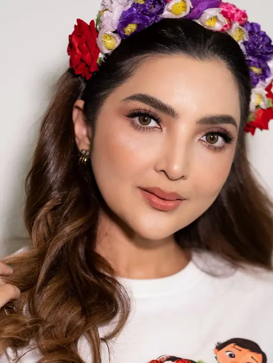 Rambut Ashanty ditata oleh @lia_hairdobali dengan gaya wavy yang dibiarkan tergerai indah. Ashanty juga mengenakan bandana bunga warna-warni yang mempertegas penampilannya sebagai Moana. [@bystefanylayata].