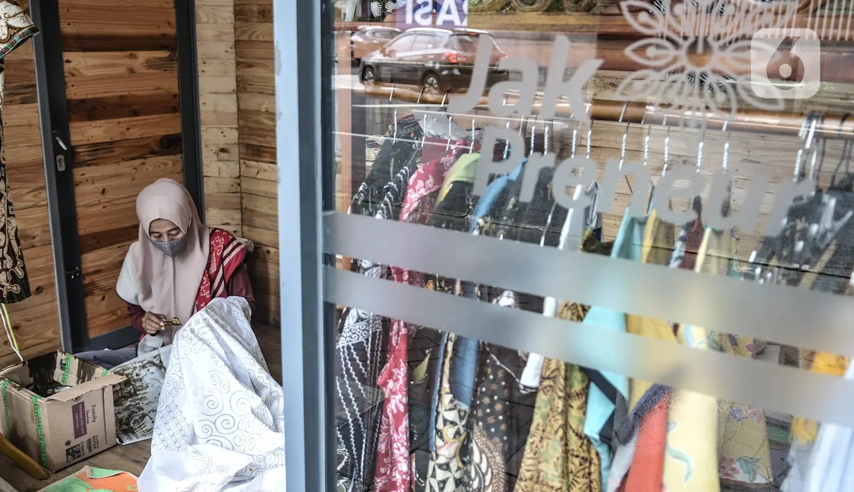 Pengrajin menyelesaikan pembuatan batik tulis di salah satu Kios Jakpreneur di Jalan Jenderal Sudirman, Jakarta, Rabu (3/2/2021). Terdapat 3 Kios Jakpreneur yang menjual berbagai produk UMKM dalam negeri, mulai dari kerajinan tangan hingga beragam jenis kuliner. (merdeka.com/Iqbal S. Nugroho)