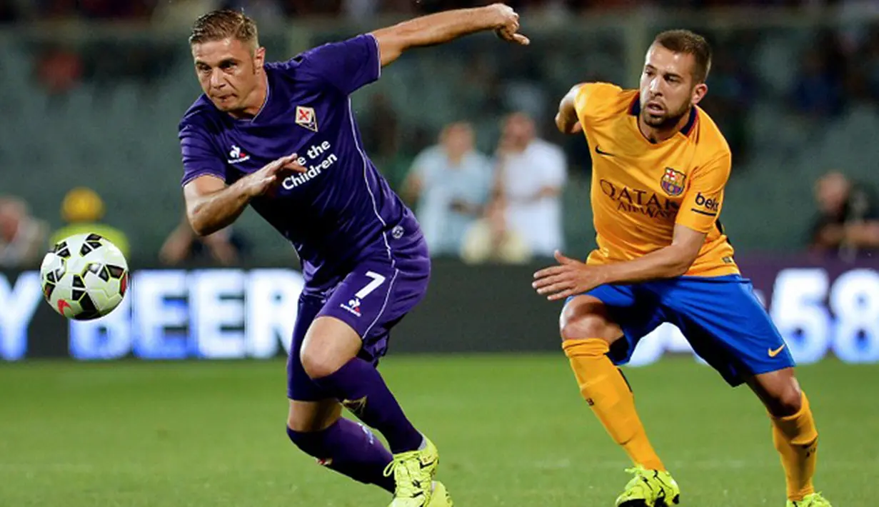 Gelandang Fiorentina, Joaquin (kiri) berusaha merebut bola dari kejaran bek Jordi Alba saat International Champions Cup (ICC) 2015 di Stadio Artemio Franchi, Senin (3/8/2015). Fiorentina menang atas Barcelona dengan Skor 2-1. (AFP PHOTO/TIZIANA FABI)