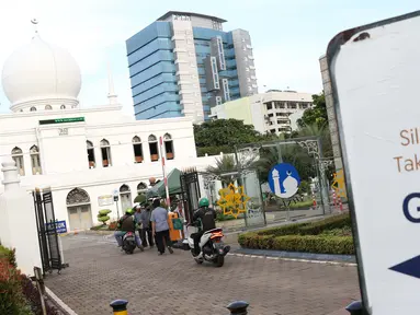 Pengendara motor antre mengambil takjil yang dibagikan dengan sistem drive thru di Masjid Agung Al-Azhar, Jakarta, Selasa (5/5/2020). Selama Ramadan, pengurus Masjid Agung Al-Azhar membagikan 300 takjil per hari buat pengendara yang melintasi lokasi tersebut. (Liputan6.com/Helmi Fithriansyah)