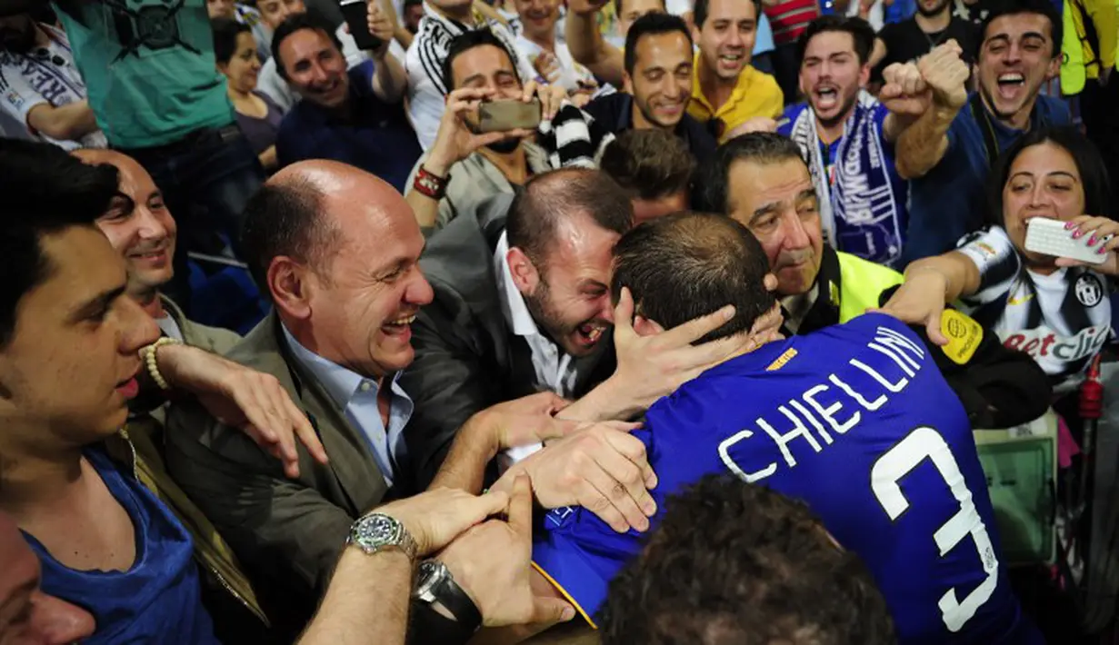 Giorgio Chiellini disambut kegembiraan pendukung Juventus. (AFP PHOTO/ CURTO DE LA TORRE)