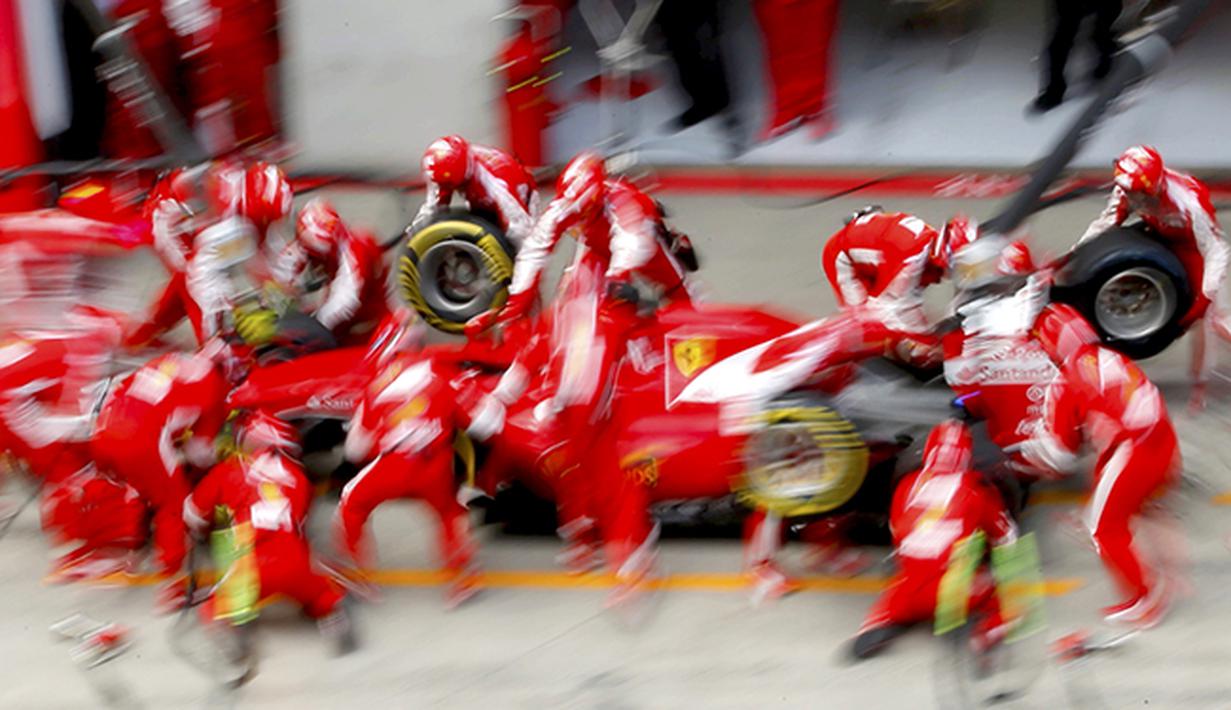 Para teknisi pebalap Ferrari asal Jerman, Sebastian Vettel saat di pitstop pada F1 GP Austria di Sirkuit Red Bull Ring di Spielberg, Austria. (REUTERS/Laszlo Balogh)