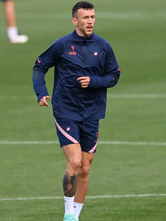 Gelandang Kroasia, Ivan Perisic melakukan pemanasan saat mengikuti sesi latihan di Firhill Stadium di Glasgow (21/6/2021). Skotlandia dan Kroasia harus memastikan kemenangan. Jika hasilnya malah imbang, kedua tim ini malah tak bisa lolos ke babak 16 besar Euro 2020. (AFP/Paul Ellis)