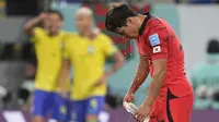 Reaksi kecewa pemain Korea Selatan, Hwang Hee-chan setelah timnya kebobolan oleh pemain Brasil, Richarlison saat laga 16 besar Piala Dunia 2022 yang berlangsung di 974 Stadium, Selasa (06/12/2022). (AP/Martin Meissner)