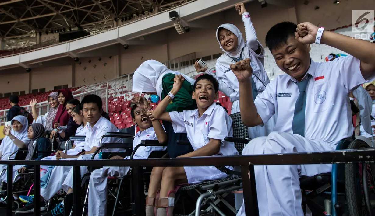 Sejumlah pelajar YPAC memberikan dukungan kepada atlet-atlet yang berlaga pada ajang Asian Para Games di SUGBK, Jakarta, Senin (8/10). Anak-anak terlihat bahagia dapat mendukung langsung di stadion. (Bola.com/Vitalis Yogi Trisna)