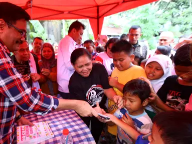 Calon Wakil Gubernur DKI Jakarta Djarot Saiful Hidayat saat membagikan buku kepada warga Petukangan Utara, Jakarta, Selasa (29/11). Djarot akan mempertahankan program KJP untuk menjamin pendidikan di Jakarta. (Liputan6.com/Gempur M Surya)