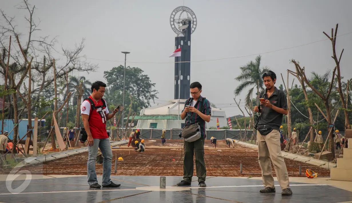 Wisatawan menggunakan gps untuk membuktikan titik nol derajat di Tugu Khatulistiwa, Kalimantan Barat, 23 Agustus 2015. Ikon wisata kota Pontianak ini masih menjadi primadona wisata sejarah bagi wisatawan lokal maupun luar. (Liputan6.com/Faizal Fanani)