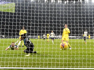 Pemain Tottenham Hotspur Harry Kane (kiri) mencetak gol ke gawang Fulham pada pertandingan Liga Inggris di Stadion Tottenham Hotspur, London, Inggris, Rabu (13/1/2021). Pertandingan berakhir dengan skor 1-1. (Shaun Botterill/Pool via AP)