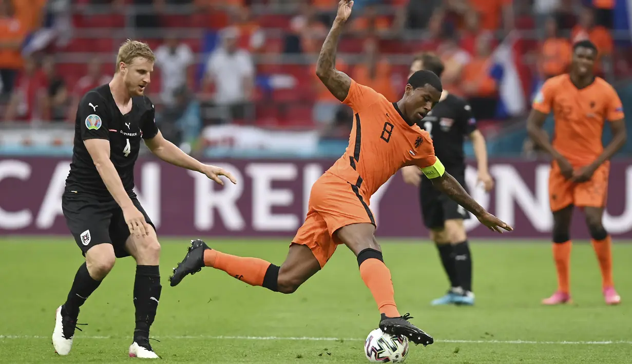 Bek timnas Austria, Martin Hinteregger berebut bola dengan gelandang Belanda, Georginio Wijnaldum pada laga kedua Grup C Euro 2020 di Johan Cruijff Arena, Amsterdam, Jumat (18/6/2021) dini hari WIB. Tuan rumah Belanda berhasil mengalahkan Austria 2-0. (John Thys, Pool via AP)