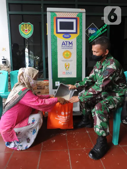 Warga menggunakan ATM Pertanian Si Komandan untuk mendapatkan beras gratis di Kodim 0606/Kota Bogor, Jawa Barat, Minggu (26/4/2020). Kementerian Pertanian bersama Bank BNI, dan TNI AD  menempatkan ATM beras gratis di sejumlah Kodim di wilayah Jabodetabek. (merdeka.com/Arie Basuki)