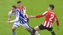 Pemain Real Sociedad, Nacho Monreal, berusaha melewati pemain Athletic Bilbao pada laga liga Spanyol di Stadion San Mames, Kamis (31/12/2020). Real Sociedad menang dengan skor 1-0. (AFP/Ander Gillenea)