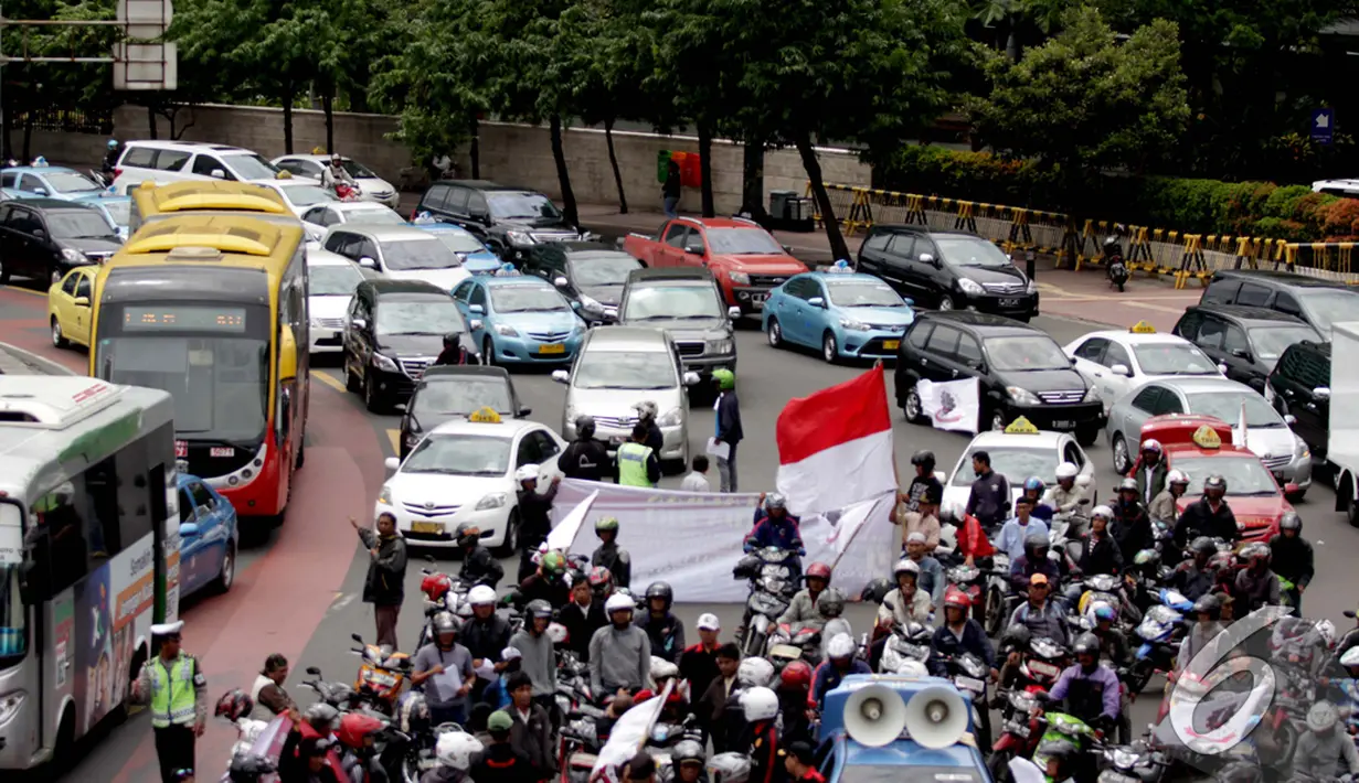 Aksi unjuk rasa menolak kebijakan larangan pengguna sepeda motor untuk melalui jalan Thamrin - Merdeka Barat membuat jalan sekitar mengalami kemacetan parah, Bundaran HI, Jakarta, Kamis (8/1/2015). (Liputan6.com/Faizal Fanani)
