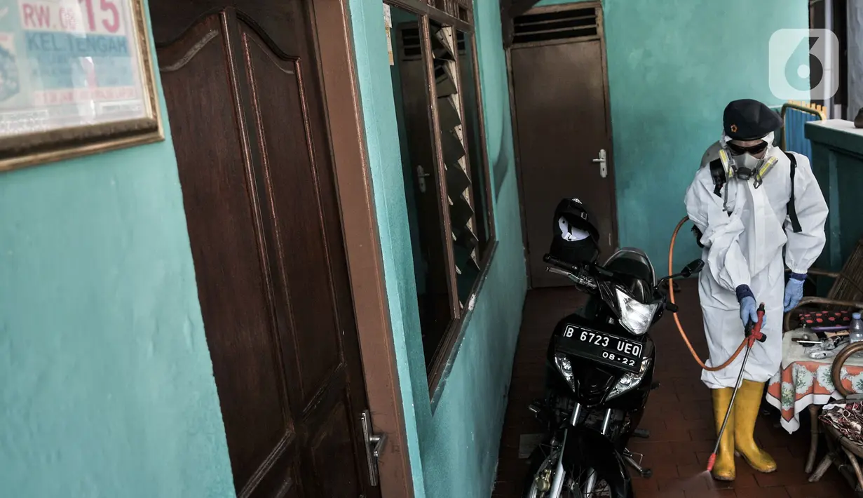 Petugas Palang Merah Indonesia (PMI) Jakarta Timur berpakaian APD menyemprotkan disinfektan di permukiman Kampung Tengah, Kramat Jati, Minggu (23/8/2020). Penyemprotan sebagai langkah sterilisasi permukiman setelah warga di Kampung Tengah dilaporkan terpapar Covid-19. (Liputan6.com/Iqbal Nugroho)