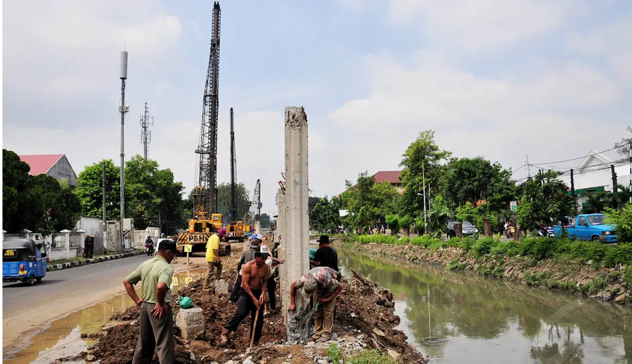 Sejumlah pekerja tengah menggarap proyek pembangunan turap Kali Utan Kayu, Jakarta, Selasa (17/6/14). (Liputan6.com/Faizal Fanani)