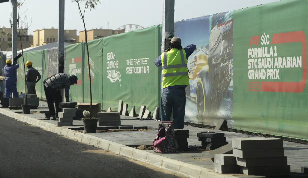 Seorang road crew bekerja di luar sirkuit corniche Formula One (F1), di Jeddah, Arab Saudi, Selasa (30/11/2021). Arab Saudi untuk pertama kalinya dipercaya menjadi tuan rumah balapan F1 2021, yang akan berlangsung 3-5 Desember mendatang. (AP Photo/Amr Nabil)