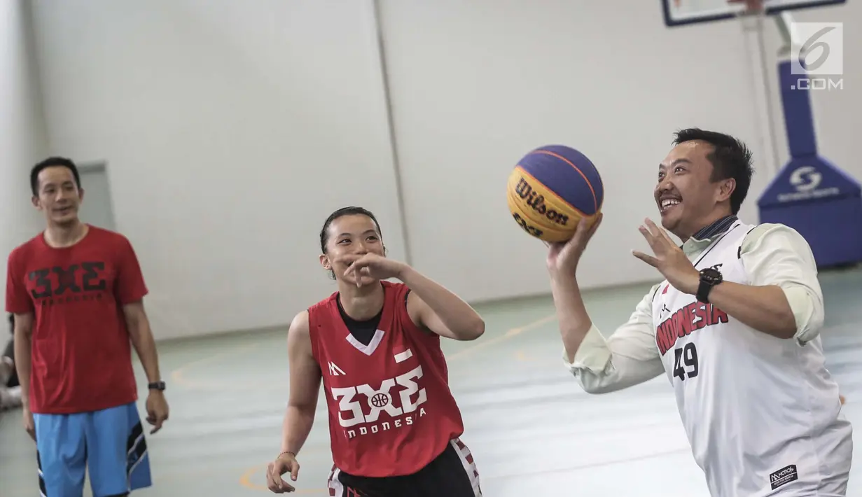 Menpora Imam Nahrawi berupaya memasukan bola saat bermain basket di Lapangan Basket Istana Kana, Jakarta, Jumat (12/1). Menpora mengunjungi Pelatnas Asian Games 2018 cabang olahraga basket untuk meninjau kesiapan para atlet. (Liputan6.com/Faizal Fanani)