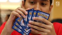 Para pecinta kartu pokemon bermain kartu The Pokémon Trading Card Game di  Kota Kasablanca, Jakarta, Kamis (8/8/2019). Tingginya permainan tukar kartu yang telah terjual sebanyak 27,2 miliar, Pokémon Trading Card Game membidik pasar Indonesia. (Liputan6.com/Angga Yuniar)