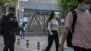 <p>Pemudik yang mengenakan masker berjalan melewati stasiun kereta bawah tanah yang ditutup di kawasan pusat bisnis di Beijing, Kamis (5/5/2022). Ibu kota China Beijing pada Kamis (5/5) mulai melonggarkan aturan karantina untuk kedatangan dari luar negeri. (AP Photo/Mark Schiefelbein)</p>