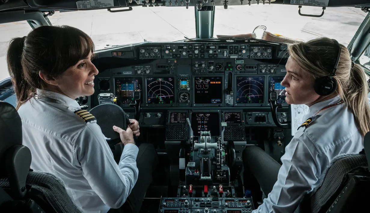 Pilot maskapai GOL Airlines, Gabriela Carneiro (kiri) jelang bertugas di Bandara Internasional Tom Jobim, Brasil (8/3). GOL Airlines menjadikan seluruh awaknya wanita saat memperingati Hari Perempuan Internasional. (AFP PHOTO/Yasuyoshi Chiba)
