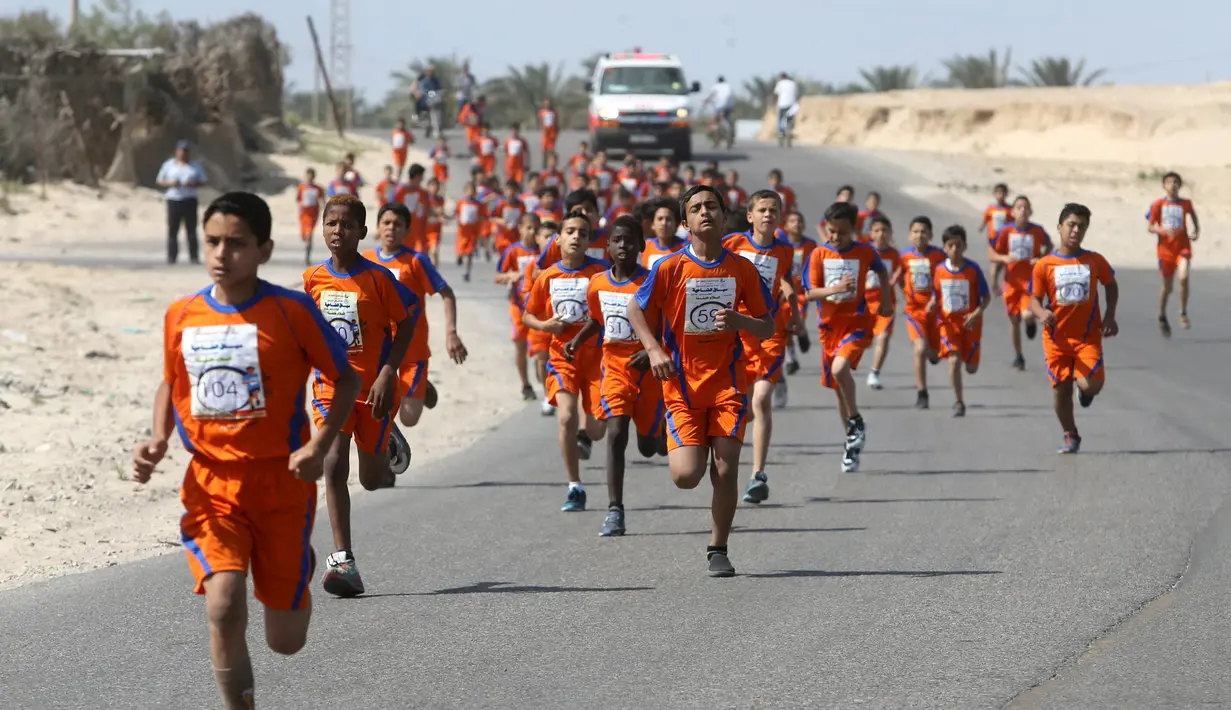 Sejumlah anak Palestina berlari selama mengikuti maraton yang diselenggarakan oleh Culture and Free Thought association di Khan Younis di Jalur Gaza selatan (28/4/2016). (REUTERS / Ibraheem Abu Mustafa)