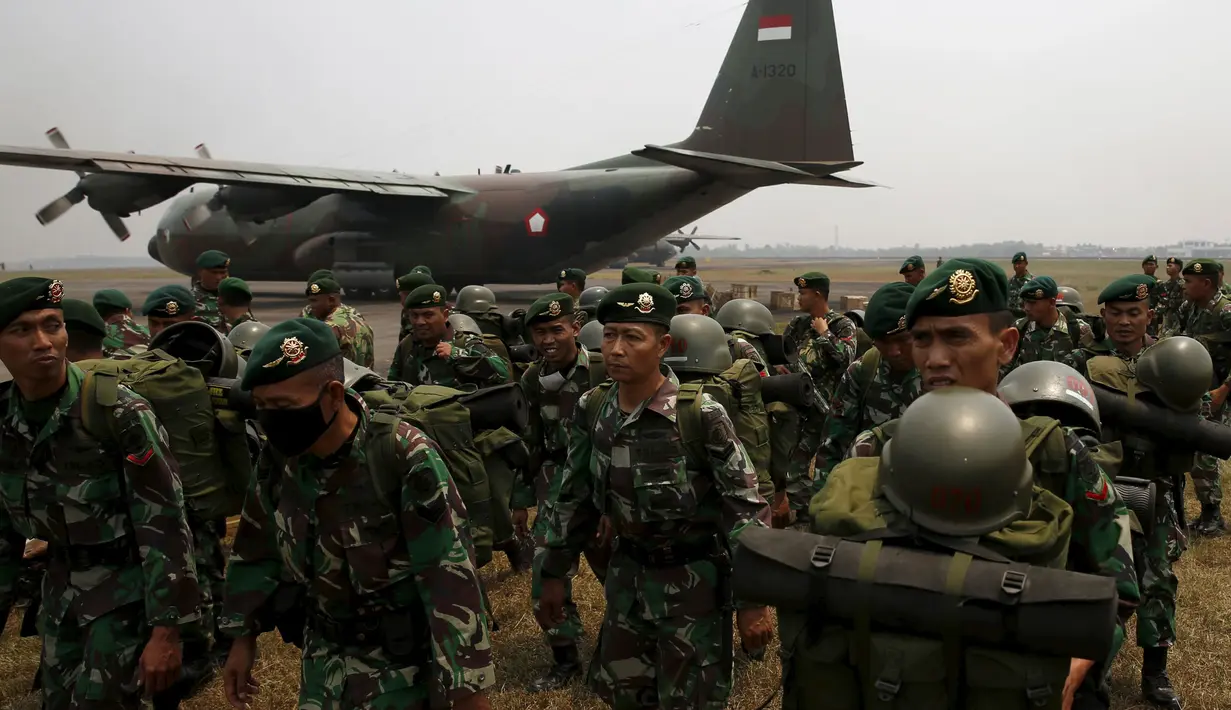 Anggota TNI berbaris saat tiba di Bandara Talang Betutu, Palembang, Kamis (10/9/2015). Sekitar 10.000 anggota TNI diterjunkan untuk membantu memadamkan kebakaran lahan yang terjadi di Sumatera bagian Selatan. (REUTERS/Beawiharta)