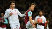 Liverpool,Pedro Chirivella (Lkiri) mencoba menghalangi pergerakan pemain West Ham United, Mark Noble pada laga Piala FA di  Stadion Boleyn Ground, Rabu (10/2/2016) dini hari WIB. (AFP/Glyn Kirk)