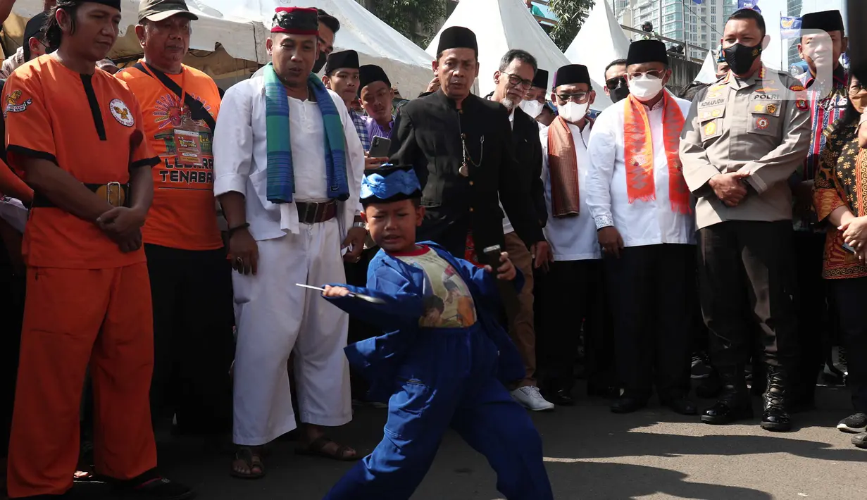 Seorang anak menampilkan pertunjukan kesenian bela diri asli Betawi Palang Pintu dalam Lebaran Tenabang 2022 di kawasan Tanah Abang, Jakarta, Sabtu (4/6/2022). Kegiatan yang menampilkan berbagai kesenian Betawi, makanan tradisional, perlombaan, dan bazar UMKM itu mengangkat tema KolaborAksi. (Liputan6.com/Angga Yuniar)