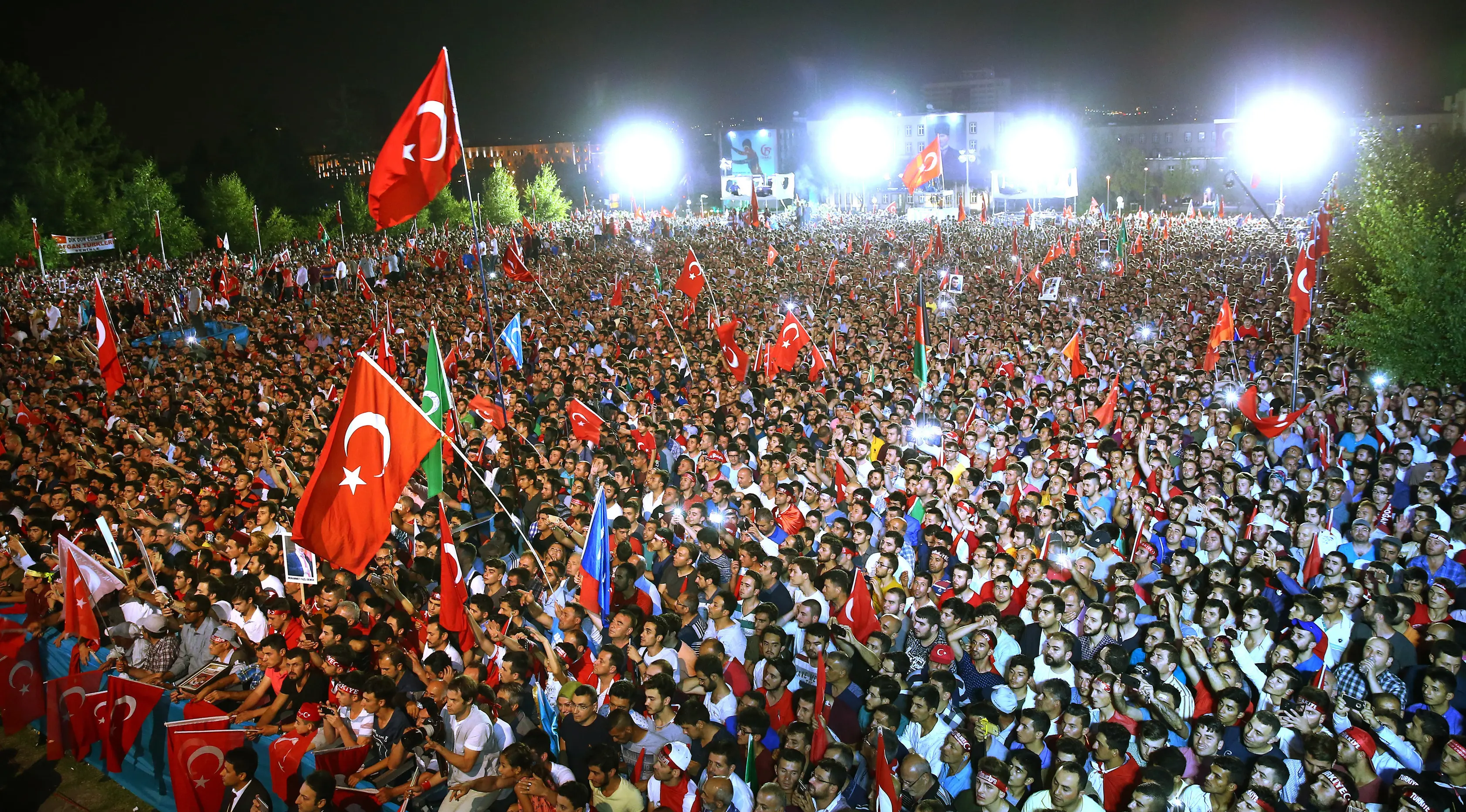 Ribuan orang berkumpul mengikuti upacara memperingati satu tahun gagalnya kudeta di Ankara, Turki (15/7). Ribuan massa turun ke jalan sambil membawa bendera Turki untuk mendengarkan pidato Presiden Erdogan. (Presidency Press Service via AP, Pool)