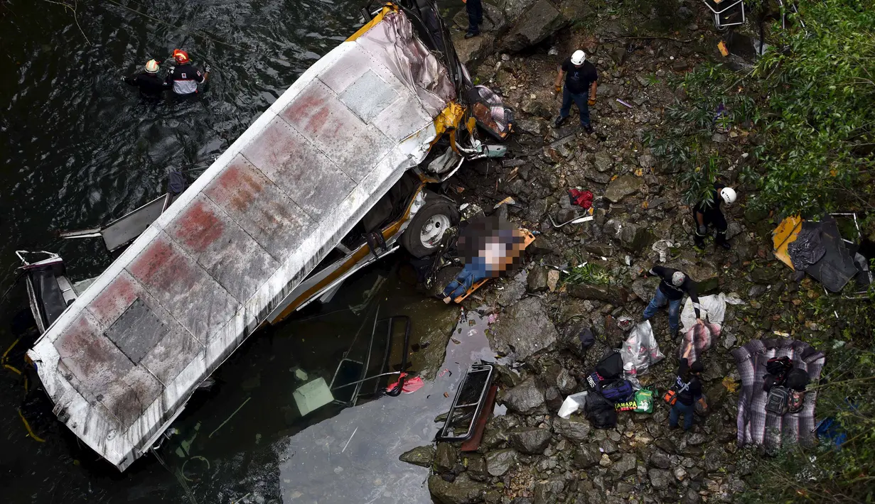 Tim SAR mengevakusi sejumlah korban dari lokasi jatuhnya bus yang membawa anggota tim sepak bola ke jurang  di Negara Bagian Veracruz, selatan Meksiko, Minggu (10/1). Sedikitnya 20 orang penumpang tewas dalam kecelakaan ini. (REUTERS/Yahir Ceballos)