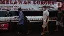 Warga menerima pembagian nasi bungkus gratis di Posko Perjuangan Rakyat (POSPERA), Jakarta, Rabu (10/3/2021). Pembagian 500 nasi bungkus beserta masker dan vitamin secara gratis setiap harinya dalam bentuk meringankan beban warga di tengah pandemi Covid-19. (merdeka.com/Imam Buhori)