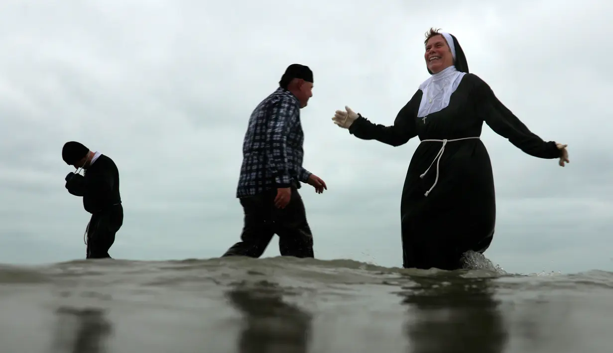 Warga Belgia menyerbu perairan Laut Utara untuk merayakan akhir pekan perrtama 2019 di Ostend, Sabtu (5/1). Cuaca dingin tidak menghalangi mereka menceburkan diri ke dalam air sebagai  tradisi tahun baru. (AP/Francisco Seco)