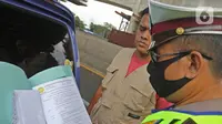 Polisi memeriksa kendaraan di Pos Penyekatan Jalur Mudik, Gerbang Tol Cikarang Barat, Bekasi, Rabu (20/5/2020). Sejak 24 April sampai 19 Mei 2020, Ditlantas Polda Metro Jaya telah memutarbalikkan 20.972 kendaraan mudik Lebaran yang hendak meninggalkan Jabodetabek. (Liputan6.com/Herman Zakharia)