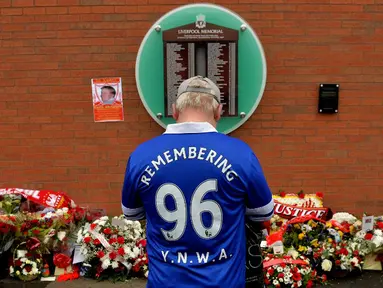 1.	Seorang suporter Everton berdoa di depan dinding bertuliskan daftar korban Tragedi Hillsborough saat peringatan 26 tahun Tragedi Hillsborough di Stadion Anfield