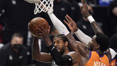 Pemain LA Clippers, Paul George, diadang pemain Phoenix Suns dalam laga game 3 Final Wilayah Barat NBA Playoffs 2021, Jumat (25/6/2021) pagi hari WIB. (AP Photo/Mark J. Terrill)