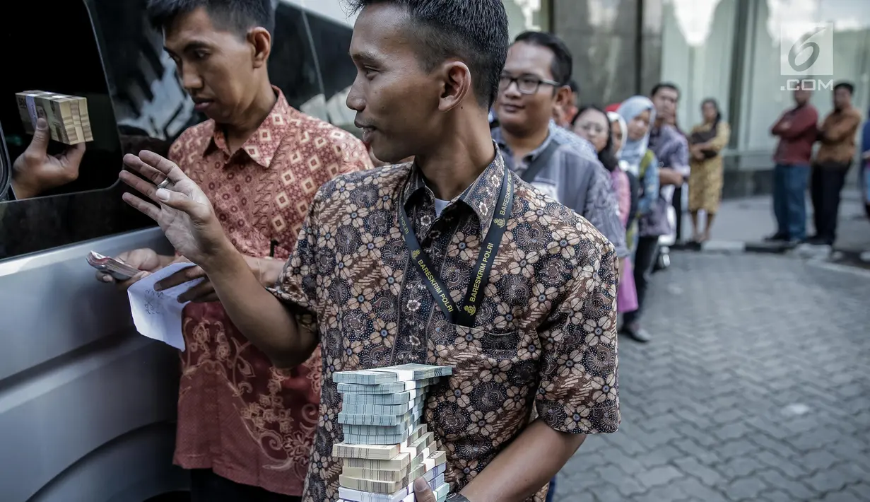 Karyawan menukarkan uang pecahan ribuan dan puluhan ribu di kantor KKP, Jakarta, Jumat (16/6). Dari sisi pengelolaan uang Rupiah, BI menyediakan uang kartal dalam berbagai pecahan yang dibutuhkan masyarakat. (Liputan6.com/Faizal Fanani)