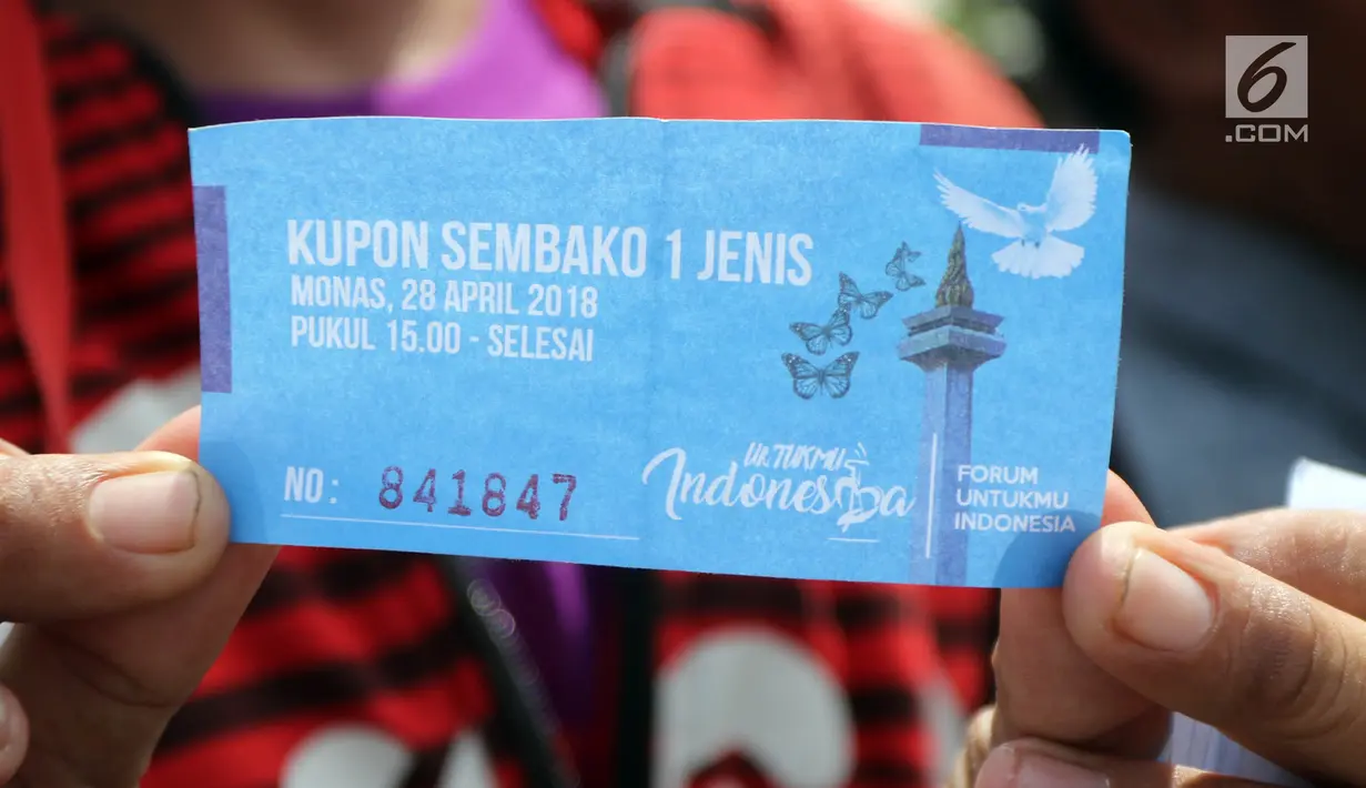 Warga menunjukkan kupon yang akan ditukarkan sembako gratis dalam acara "Untukmu Indonesia" di lapangan Monas, Jakarta, Sabtu (28/4). (Liputan6.com/Arya Manggala)