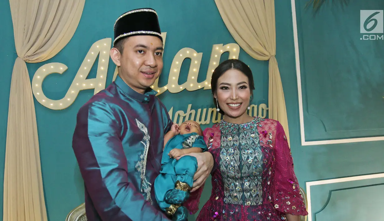 Aktris Ayu Dewi bersama suami Regi Datau dan anak keduanya Mohamad Aqlan Ukasyah Datau berfoto bersama usai acara Mohuntingo di kawasan Tebet, Jakarta, Minggu (27/08). (Liputan6.com/Herman Zakharia)