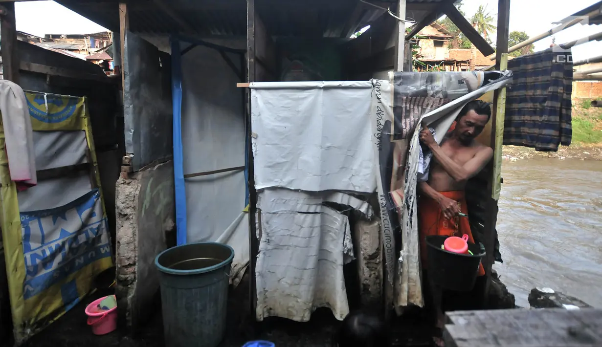 Aktivitas warga saat mandi cuci kakus (MCK) di toilet umum kawasan bantaran Kali Ciliwung, Jakarta, Senin (19/11). Saat ini, tercatat sekitar 500 ribu penduduk DKI Jakarta tidak memiliki akses sanitasi yang layak. (Merdeka.com/Iqbal Nugroho)