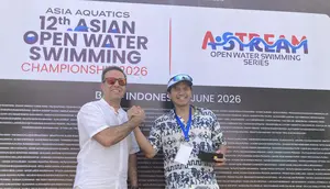 Executive Director Asia Aquatics Farid Fattahian (kanan) saat memberikan medali kepada Ketua Harian PB Akuatik Indonesia Harlin E. Rahardjo saat 12th Asian Open Water Swimming Championship 2026 di Pantai Jimbaran pada Minggu (14/6/2026). (Bola.com/Alit Binawan)