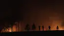 Orang-orang berkumpul di jalan saat api menghanguskan hutan di dekat Ituzaingo, provinsi Corrientes, Argentina (19/2/2022). Kebakaran terus melanda provinsi Corrientes yang telah menghanguskan lebih dari setengah juta hektar. (AP Photo/Rodrigo Abd)