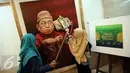 Pengunjung berfoto di dekat lukisan Presiden RI ke-4 Abdurrahman Wahid (Gusdur) saat pameran di Gedung PBNU, Jakarta, Senin (30/1). Pameran tersebut digelar dalam rangka Harlah NU ke-91. (Liputan6.com/Johan Tallo)