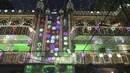 Orang-orang melewati masjid yang didekorasi pada perayaan hari kelahiran Nabi Muhammad SAW atau biasa disebut Maulid Nabi di Lahore, Pakistan, Senin (18/10/2021). Peringatan Maulid Muhammad tak hanya diperingati umat Islam di Indonesia, tapi juga di berbagai negara. (Arif ALI/AFP)