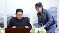 Kim Jong-un sedang menandatangani sebuah buku tamu dengan didampingi adiknya Kim Yo-jong. (AP)
