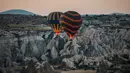 Balon udara membawa wisatawan naik ke langit saat matahari terbit di Kapadokia, Turki, Selasa (7/8). Kapadokia memiliki sejumlah keajaiban alam, khususnya Cerobong Peri (Fairy Chimney). (AP Photo/Emrah Gurel)