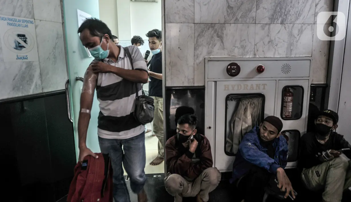 Peserta keluar ruangan usai menjalani penghapusan tato di Masjid Baitul Muhyi, Kompleks Wali Kota, Jakarta Timur, Jakarta, Kamis (29/4/2021). 
Layanan hapus tato gratis untuk 550 orang se-DKI Jakarta yang berlangsung di 10 lokasi berbeda. (merdeka.com/Iqbal S. Nugroho)