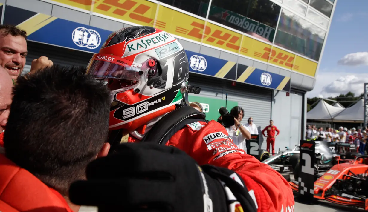 Pembalap Ferrari Charles Leclerc memeluk timnya usai memenangkan F1 GP Italia 2019 di Sirkuit Monza, Minggu (8/9/2019). Leclerc menjuarai F1 GP Italia 2019 setelah pertarungan alot melawan duo pembalap Mercedes, Lewis Hamilton dan Valtteri Bottas. (AP Photo/Luca Bruno)