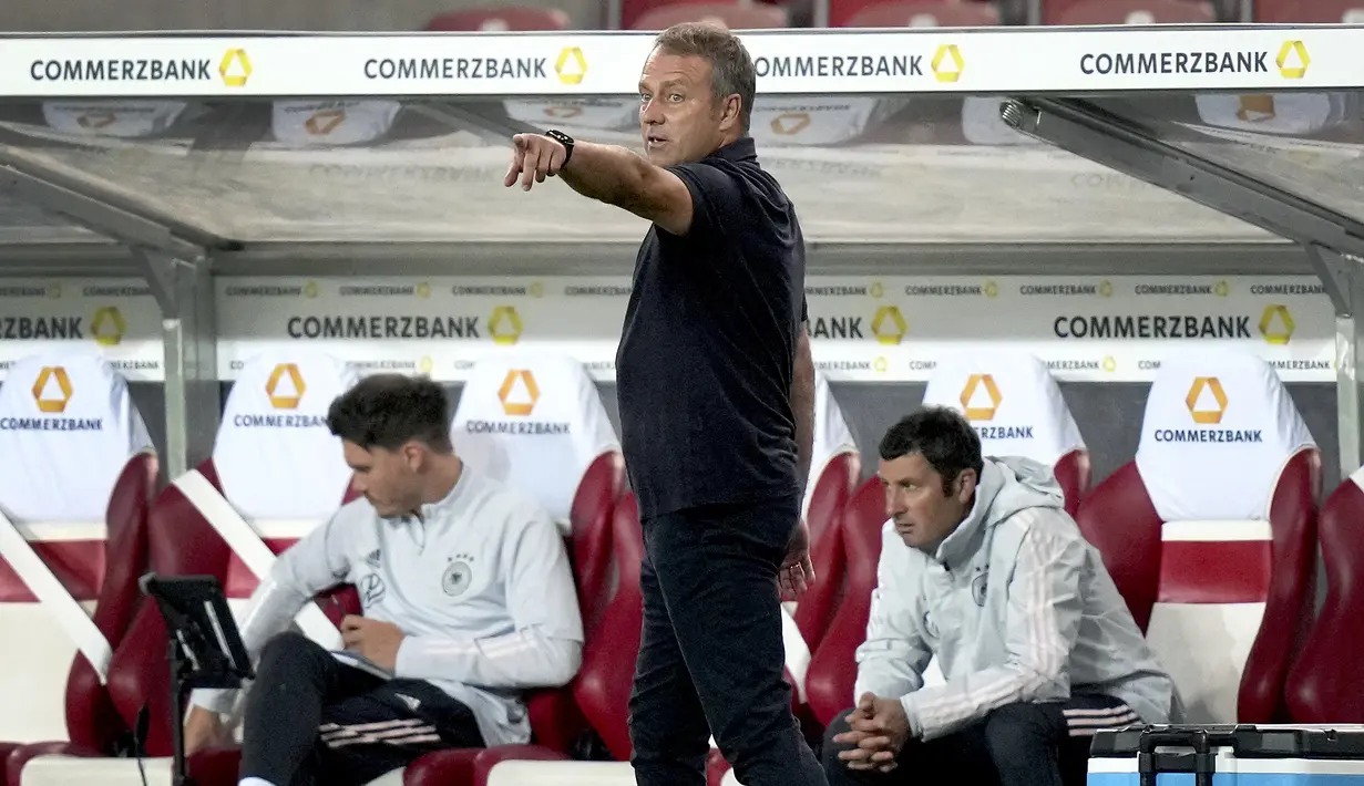 Pelatih Jerman, Hansi Flick menginstruksikan pemainnya saat bertanding melawan Armenia pada pertandingan grup J Kualifikasi Piala Dunia 2022 di stadion Mercedes-Benz Arena di Stuttgart, Jerman, Senin (6/9/2021). Jerman atas Armenia 6-0. (AP Photo/Matthias Schrader)