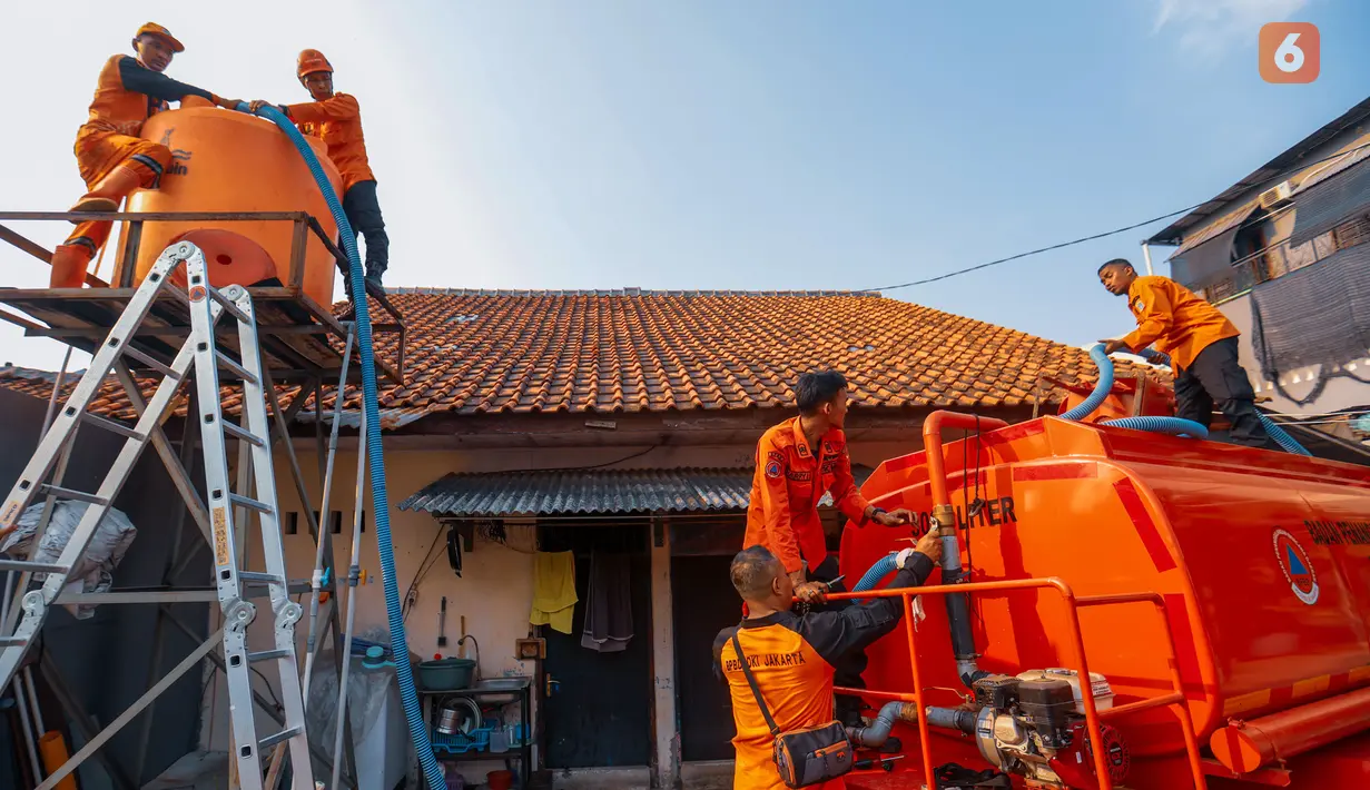 Petugas mengisi wadah toren 1000L milik warga saat pendistribusian air bersih oleh BPBD DKI Jakarta di Cilandak Timur, Jakarta Selatan, Senin (21/9/2026). Penyaluran dilakukan untuk membantu warga memenuhi kebutuhan air selama kekeringan berlangsung. (KLY/Budy Santoso)