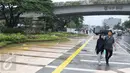 Pejalan kaki melintasi trotoar di Jalan Jatibaru Raya, Tanah Abang, Jakarta, Senin (21/11). Meskipun belum sepenuhnya selesai, namun trotoar yang dulu dipenuhi PKL tersebut kini telah berubah menjadi bersih dan asri. (Liputan6.com/Immanuel Antonius)